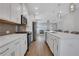 Modern kitchen with white cabinets, stainless steel appliances, a large island, and open layout is sure to please at 1768 Evenstad Way, Smyrna, GA 30080