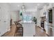 Bright kitchen features an island with seating, stainless steel appliances and wood flooring at 1768 Evenstad Way, Smyrna, GA 30080