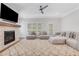Bright living room features a fireplace, large windows, a ceiling fan, and soft neutral-colored furniture at 1768 Evenstad Way, Smyrna, GA 30080