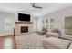 Inviting living room with a stone fireplace, plantation shutters, and plush seating, creating a cozy ambiance at 1768 Evenstad Way, Smyrna, GA 30080