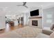 Open concept living room flows into a kitchen with an island, a fireplace, and neutral decor at 1768 Evenstad Way, Smyrna, GA 30080