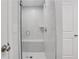 Modern walk-in shower featuring white marble-style tile, a built-in bench, and sleek fixtures at 1768 Evenstad Way, Smyrna, GA 30080