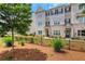 Charming townhouse with brick and siding, fenced yard, and well-manicured landscaping provides a welcoming curb appeal at 1768 Evenstad Way, Smyrna, GA 30080