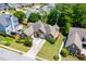 Picturesque aerial view of a single-Gathering home with a manicured lawn, mature trees, and a private driveway at 2041 Democracy Dr, Buford, GA 30519