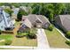 Aerial view showcasing the home's well-manicured lawn, landscaping, and long driveway at 2041 Democracy Dr, Buford, GA 30519
