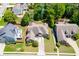 Beautiful aerial view of a single-Gathering home nestled on a lush green lot, showcasing a manicured lawn and mature trees at 2041 Democracy Dr, Buford, GA 30519