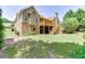 Spacious backyard featuring a large deck, mature trees, and well-maintained lawn at 2041 Democracy Dr, Buford, GA 30519
