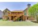 Exterior view of backyard with a large wooden deck and stairs leading to the lawn at 2041 Democracy Dr, Buford, GA 30519