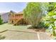 Landscaped backyard featuring a large wooden deck, stairs, and mature trees at 2041 Democracy Dr, Buford, GA 30519