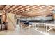Unfinished basement with exposed ceiling and tables at 2041 Democracy Dr, Buford, GA 30519