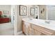 Bathroom featuring double sinks, wood cabinetry, and a large mirror over the counter at 2041 Democracy Dr, Buford, GA 30519
