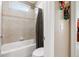 Cozy bathroom features a white bathtub, tile walls, and a shower curtain at 2041 Democracy Dr, Buford, GA 30519