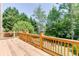 Wooden deck with wood railings offering beautiful views of the surrounding landscape at 2041 Democracy Dr, Buford, GA 30519