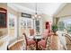 Cozy dining area featuring a glass table and brightly patterned upholstered chairs near natural light at 2041 Democracy Dr, Buford, GA 30519
