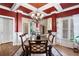 Formal dining room with coffered ceilings, a chandelier, and ample natural light at 2041 Democracy Dr, Buford, GA 30519