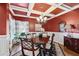 Formal dining room with coffered ceilings, hardwood floors, and elegant chandelier at 2041 Democracy Dr, Buford, GA 30519