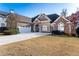 Lovely home features a two-car garage, well-manicured lawn, and inviting curb appeal at 2041 Democracy Dr, Buford, GA 30519
