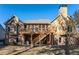 View of the home's exterior featuring a deck, screened in porch and a spacious backyard and mature trees at 2041 Democracy Dr, Buford, GA 30519