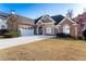 Charming home with a well-manicured lawn, a two-car garage, and inviting curb appeal at 2041 Democracy Dr, Buford, GA 30519