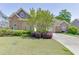 Charming home with stone accents, lush lawn, mature landscaping and a long driveway at 2041 Democracy Dr, Buford, GA 30519