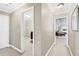 Hallway leading to multiple rooms with neutral color and natural light at 2041 Democracy Dr, Buford, GA 30519