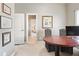 Bright home office with custom desk and a view to another room through the doorway at 2041 Democracy Dr, Buford, GA 30519