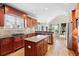 Elegant kitchen with stainless steel appliances, granite countertops, a kitchen island, and a view of the living room at 2041 Democracy Dr, Buford, GA 30519