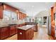 Stylish kitchen with granite countertops, wood cabinetry, and open concept to living room at 2041 Democracy Dr, Buford, GA 30519