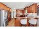 Modern kitchen with granite countertops, stainless steel appliances, and wooden cabinets at 2041 Democracy Dr, Buford, GA 30519