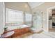 Main bathroom showcases a soaking tub, glass shower, and a stylish design at 2041 Democracy Dr, Buford, GA 30519