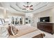 Spacious main bedroom with trey ceiling, fireplace view, and dark wood dresser at 2041 Democracy Dr, Buford, GA 30519