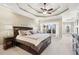 Spacious primary bedroom with decorative tray ceilings and multiple windows at 2041 Democracy Dr, Buford, GA 30519