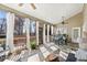 Screened porch with outdoor dining area, comfortable seating, and nature views at 2041 Democracy Dr, Buford, GA 30519