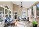 Relaxing screened porch features comfortable seating with wood flooring and an open view at 2041 Democracy Dr, Buford, GA 30519