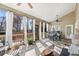 Well-lit sunroom with ample windows, a ceiling fan, and comfortable furnishings at 2041 Democracy Dr, Buford, GA 30519