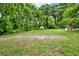 Expansive backyard featuring lush greenery, a small storage shed, and ample space for outdoor activities at 232 S Candler St, Villa Rica, GA 30180