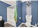 Bathroom with a shower/tub, blue walls and toilet with cute toilet paper at 232 S Candler St, Villa Rica, GA 30180
