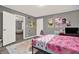 Cheerful bedroom featuring pink decor, wood-look vinyl flooring, and colorful wall decorations at 232 S Candler St, Villa Rica, GA 30180