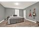 Cozy bedroom featuring wood-look vinyl flooring and paneled walls at 232 S Candler St, Villa Rica, GA 30180
