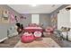 Playful bedroom with pink accents, beanbag chairs, and Hello Kitty-themed decor at 232 S Candler St, Villa Rica, GA 30180