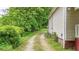 The gravel driveway leads to the side of the house, bordered by lush greenery at 232 S Candler St, Villa Rica, GA 30180