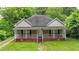 Charming single-story home with a welcoming front porch and lush green lawn at 232 S Candler St, Villa Rica, GA 30180