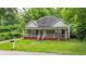 Quaint one-story home featuring a cozy front porch and a well-maintained lawn at 232 S Candler St, Villa Rica, GA 30180