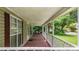 View of the covered front porch with an American flag at 232 S Candler St, Villa Rica, GA 30180