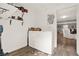 Functional laundry room with a washer, dryer, shelving, and wood-look vinyl flooring at 232 S Candler St, Villa Rica, GA 30180