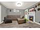 Inviting living room with cozy sectional sofa, fireplace, and wood-look vinyl flooring at 232 S Candler St, Villa Rica, GA 30180