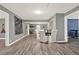 Open living area with laminate wood floors, light grey paint, and views to other rooms at 232 S Candler St, Villa Rica, GA 30180