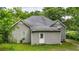 Rear exterior showcasing the home's back entrance, gray siding, and well-maintained yard at 232 S Candler St, Villa Rica, GA 30180
