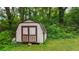 Backyard shed with a wooden door and a green grass surrounding at 232 S Candler St, Villa Rica, GA 30180