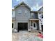 Under-construction gray two-story home featuring an attached garage and a classic architectural style at 27 Benscot Dr, Austell, GA 30106